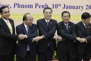 Chana's Premier Li Keqiang, center, shakes hands with his counterpart, Nguyen Xuan Phuc, second from left, of Vietnam,  Prayuth Chan-o-cha, left, of Thailand, Hun Sen, second from right, of Cambodia, and Thongloun Sisolith, right, of Laos, before an opening of the 2nd Mekong Lancang Cooperation Leaders’ Meeting, in   Phnom Penh, Cambodia, Wednesday, Jan. 10, 2018. Leaders of nations along Southeast Asia's Mekong River gather Wednesday in the Cambodian capital amid a push by China to build more dams that are altering the water flow and have raised environmental concerns. (AP Photo/Heng Sinith)
